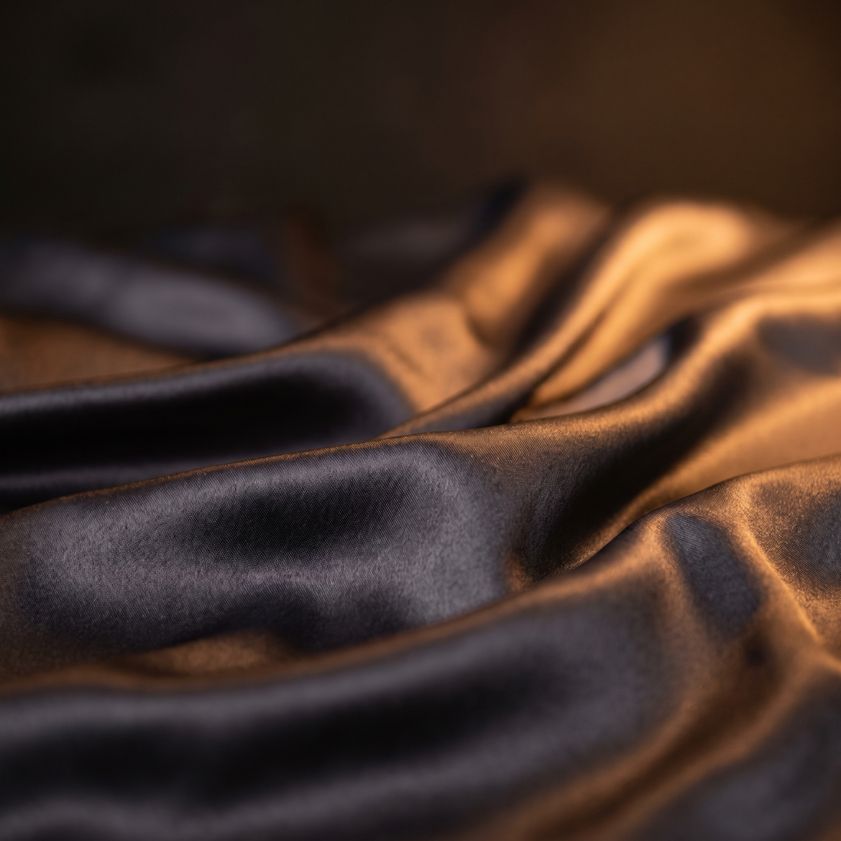 Close detail of charcoal satin sheen and folds